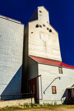 A large white building with a red roof. The building is empty and has a lot of windows clipart