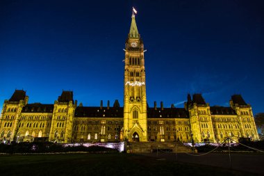 The building is lit up at night, giving it a majestic and grand appearance. The clock tower is prominently visible, adding to the building's impressive stature clipart