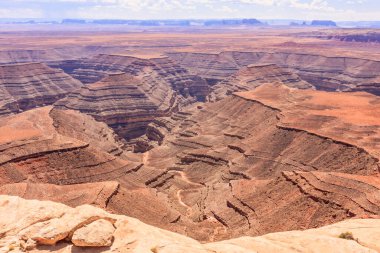 Muley Point is a remote, scenic overlook in southern Utah. Monument Valley is visible in the distance while the San Juan River cuts into the canyon below. clipart