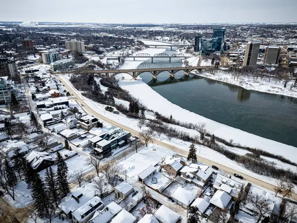 Altında nehir akan karlı bir şehir. Evler karla kaplı ve sokaklar bomboş.
