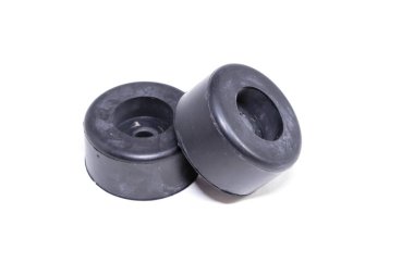 Beyaz arka plana iki siyah lastik tıpası yerleştiriliyor. Engelleyicilerin boyutları ve şekilleri aynı.