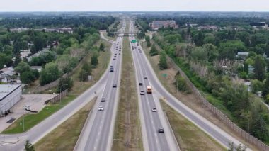 Ortasından geçen bir otobüsle dolu bir otoyol. Yol geniş ve üzerinde birçok araba var.