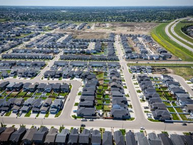 Birçok evi ve birkaç arabası olan bir banliyö mahallesi. Evlerin çoğu beyaz ve cadde ağaçlarla kaplı.