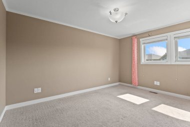 Beyaz duvarlı ve pembe perdeli bir oda. Oda boş ve minimalist bir görünüşü var.