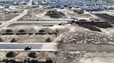 4K aerial view of new land development at Brighton Ranch in Saskatoon, showing future residential expansion.