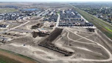 4K aerial view of new land development at Brighton Ranch in Saskatoon, showing future residential expansion.