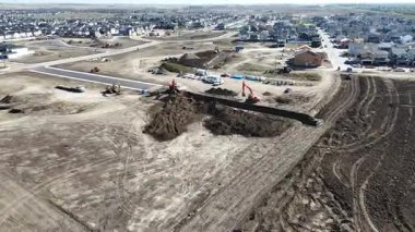 4K aerial view of new land development at Brighton Ranch in Saskatoon, showing future residential expansion.
