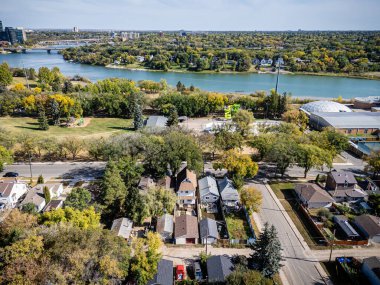 Aerial view of King George in Saskatoon, Saskatchewan, featuring homes, parks, and the South Saskatchewan River nearby.