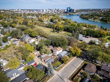Drone aerial of King George, Saskatoon, showing residential streets, schools, and riverside green space.