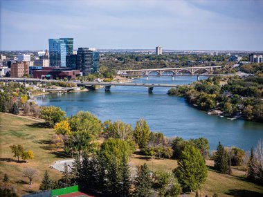 Downtown Saskatoon looking over the South Saskatchewan River and local park.