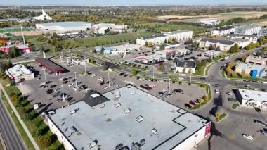 Aerial view of University Heights Suburban Centre in Saskatoon, showing condos, retail, and schools in crisp 4K.