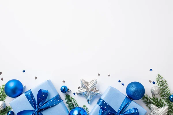 stock image Christmas Eve concept. Top view photo of blue white silver baubles big present boxes with ribbon bows star ornaments pine branches in frost and confetti on isolated white background with copyspace