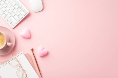 St Valentine's Day concept. Top view photo of notepad pen keyboard computer mouse glasses heart shaped candles and cup of coffee on saucer on isolated pastel pink background with copyspace