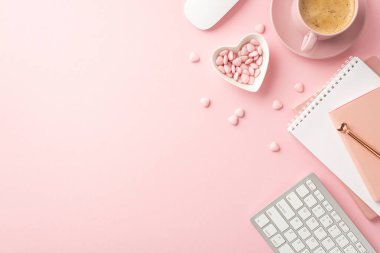 St Valentine's Day concept. Top view photo of notepads pen keyboard computer mouse heart shaped plate with sprinkles and cup of coffee on saucer on isolated light pink background with copyspace