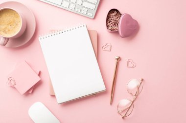 8-march concept. Top view photo of stationery planners stylish pen glasses heart shaped clips sticky note paper keyboard and mug of frothy coffee on isolated pastel pink background with blank space
