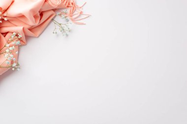 Hello spring concept. Top view photo of pink plaid and gypsophila flowers on isolated white background with copyspace