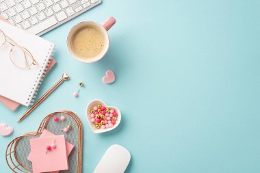 Top view photo of keyboard notepads pen heart shaped stationery holder pushpins sticky note paper glasses computer mouse and mug of coffee on isolated pastel blue background with copyspace