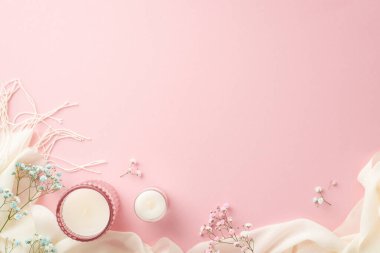 Hello spring concept. Top view photo of candles in glass holders gypsophila flowers and white soft plaid on isolated pastel pink background with copyspace