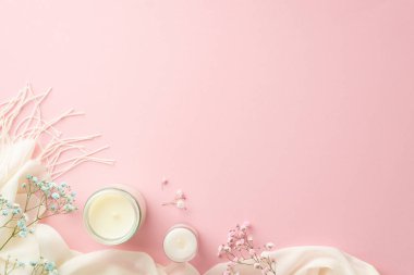 Hello spring concept. Top view photo of candles gypsophila flowers and white plaid on isolated light pink background with copyspace