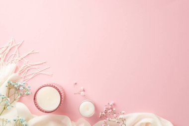 Hello spring concept. Top view photo of candles in glass holders gypsophila flowers and white soft scarf on isolated pastel pink background with empty space