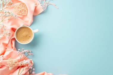 Hello spring concept. Top view photo of cup of hot drinking two rattan hearts gypsophila flowers and pink plaid on isolated pastel blue background with copyspace