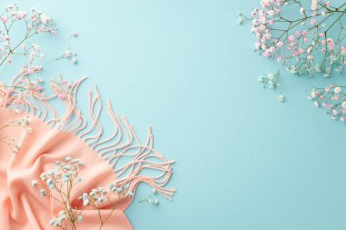 Hello spring concept. Top view photo of pink and blue gypsophila flowers and soft scarf on isolated pastel blue background with empty space