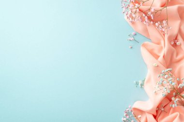 Spring mood concept. Top view photo of gypsophila flowers and pink soft plaid on isolated pastel blue background with blank space