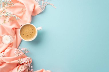 Hello spring concept. Top view photo of cup of frothy coffee small candle gypsophila flowers and pink scarf on isolated pastel blue background with copyspace