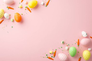 Easter celebration concept. Top view vertical photo of orange green yellow easter eggs small carrots and sprinkles on isolated light pink background with blank space