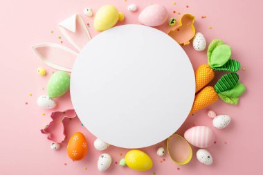 Easter concept. Top view photo of white circle colorful easter eggs bunny ears backing molds carrots and sprinkles on isolated pastel pink background with blank space