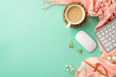 Top view photo of keyboard computer mouse cup of coffee on rattan placemat golden pen binder clips adhesive tape gypsophila flowers and pink scarf on isolated teal background with copyspace