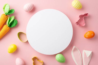 Easter celebration concept. Top view photo of white circle colorful easter eggs bunny ears backing molds and carrots on isolated pastel pink background with blank space