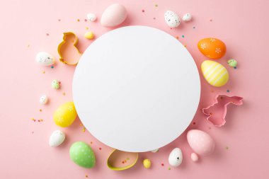 Easter decorations concept. Top view photo of white circle colorful easter eggs baking molds and sprinkles on isolated pastel pink background with copyspace