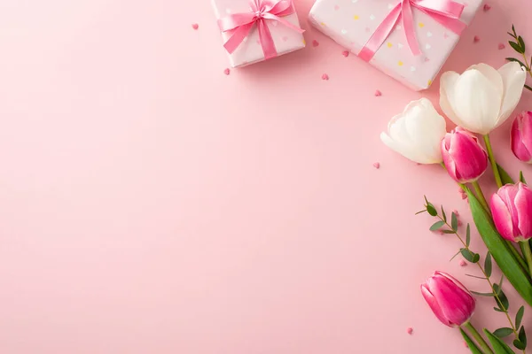 stock image Mother's Day concept. Top view photo of present boxes with ribbon bows bouquet of spring flowers and heart shaped sprinkles on isolated pastel pink background with copyspace