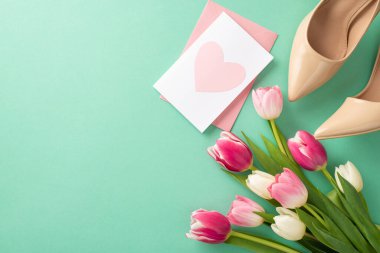 Anneler Günü kutlaması konsepti. Yüksek topuklu ayakkabılar, kartpostallar, pastel deniz mavisi arkaplanlı laleler ve boş alanlar.