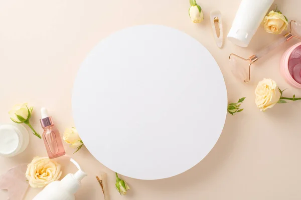 Perfect for branding, advertising, or promotions, this conceptual skin care top view flat lay features pump bottles, a face roller, and an empty circle on a pastel beige backdrop
