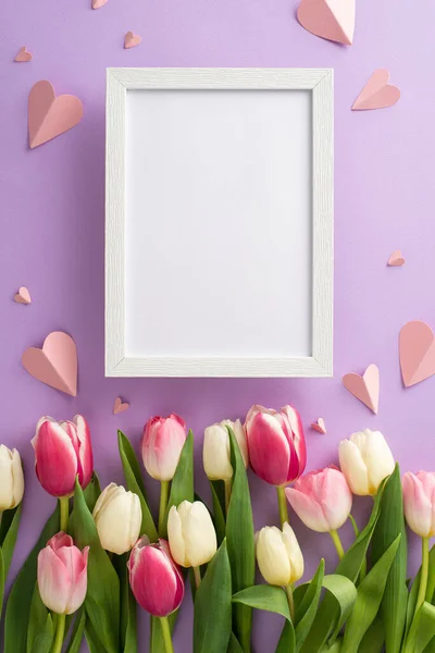 stock image Mother's Day presents concept. Top vertical view flat lay of tulip flowers, and pink paper hearts on a soft pastel purple background with empty frame for text or advert