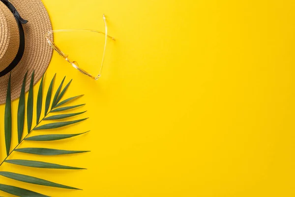 stock image A vibrant summer getaway background with a top view flat lay of a sunhat, palm leaves, sunglasses on a bright yellow background. The empty space is perfect for text or advertisements