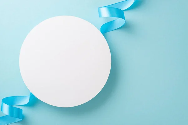 stock image Top view photo of white empty circle with a pastel blue ribbon on an isolated light background with copy-space