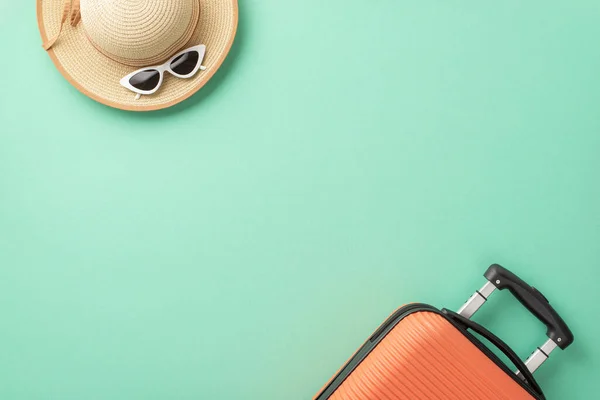 stock image A top view of an orange suitcase, beach gear, sunglasses, and sunhat on a teal backdrop, an ideal travel-themed image