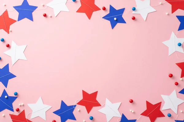 stock image Set stage for an Independence Day extravaganza with this patriotic arrangement. From top view, star garland, round sprinkles, festive accents on pastel pink background. Space available for text or ad