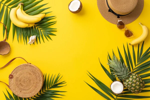 Stock image Savoring the allure of summer. Top view of beach must-haves, purse, glasses, sunhat, palm leaves, and tantalizing exotic fruits on a vibrant yellow backdrop with frame for text or advertorial content