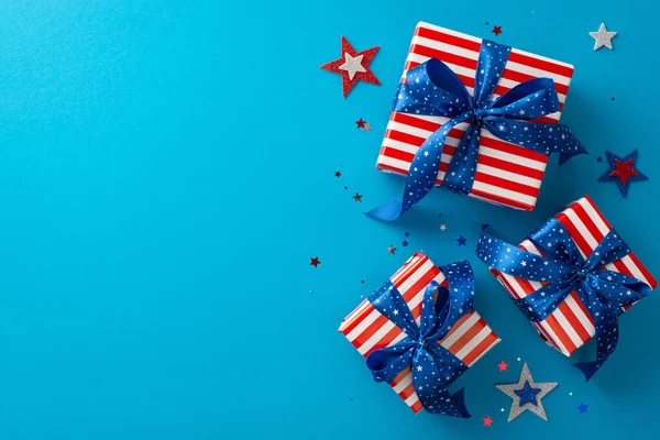 stock image Witness brilliance of overhead decorations, featuring sparkling stars, confetti, gift boxes elegantly wrapped in timeless USA flag pattern. Against blue backdrop, providing space for text or advert