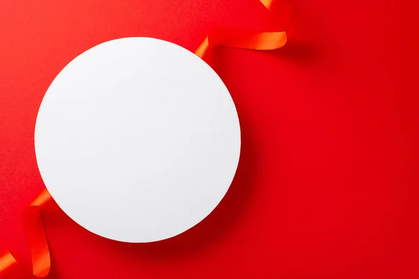 Stock image Top view photo of white empty circle surrounded by bright red ribbon on isolated red background with copy-space