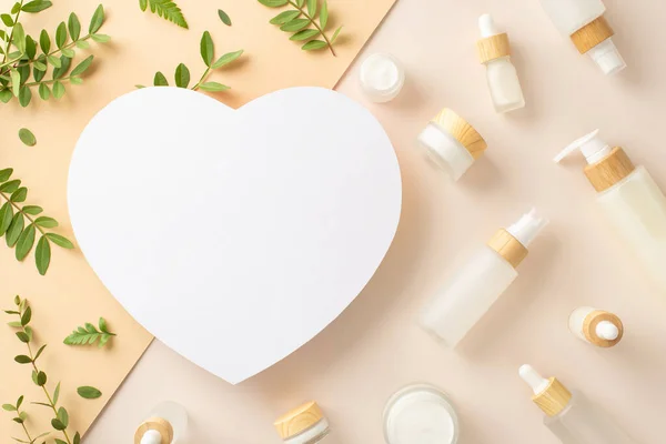 stock image Natural cosmetic products concept. High view photo of empty heart shape surrounded by cosmetics containers, eucalyptus and bracken leaves on isolated two-toned beige background with copy-space