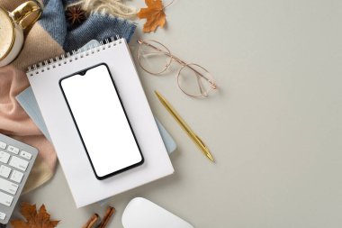 Sonbaharda serbest çalışmanın rahatlığını tecrübe edin. Bu üstteki resimde telefon, yaldızlı kalem ve gözlüklü, sıcak kakao ve bej renkli eşarp ile izole edilmiş ve telif alanı olan sıcak kakao var.