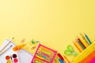 Bu büyüleyici üst düzey kompozisyonla eğlenceli erken eğitim alanına adım atın: parlak sarı arkaplan karşısında canlı bir okul malzemeleri dizisi, metin veya tanıtım mesajları için telif alanı