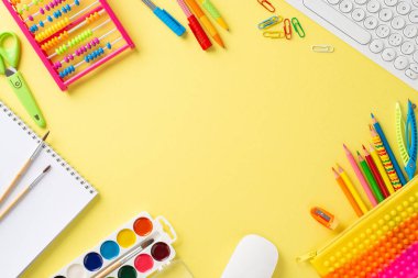 Kendinizi uzak eğitim dünyasına daldırın. Bu büyüleyici üst görünüm görüntüsüyle bir klavye ve parlak çocuk kırtasiyesini sarı arka planda sergiliyorsunuz. Mesaj ya da reklam için mükemmel.