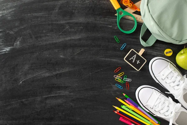 stock image Discover lecture hall aesthetic with this top view photograph: a blackboard embellished with accessories and array of stationery on an isolated background, offering copyspace for adverts or text