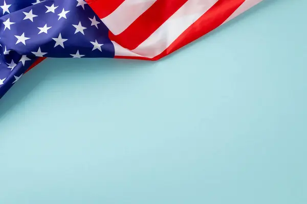Empowerment and appreciation for female workers on Labor Day. Top view of wavy USA flag on pastel blue background with space for text or advert